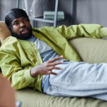 Image of man on couch talking to a behavioral therapist
