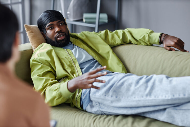 Image of man on couch talking to a behavioral therapist