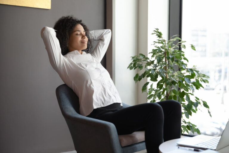 Image of woman leaning back in chair having overcome new year anxiety
