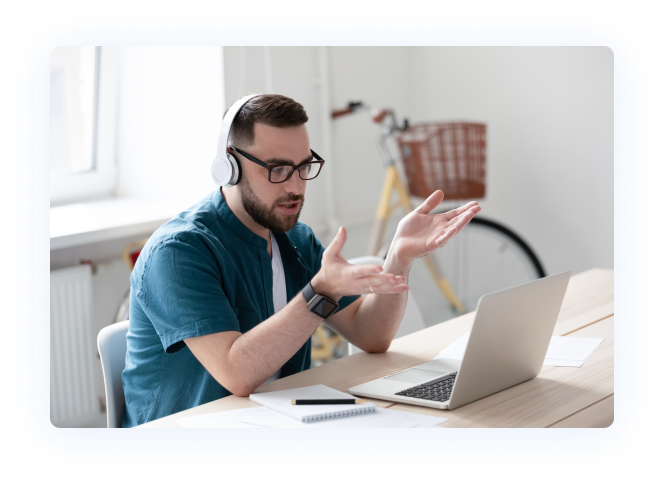 man talking to a patient from a computer