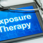 Exposure therapy for OCD represented by Exposure Therapy on a blue tablet screen draped with a stethoscope.