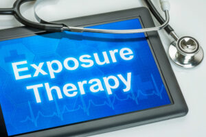Exposure therapy for OCD represented by Exposure Therapy on a blue tablet screen draped with a stethoscope.